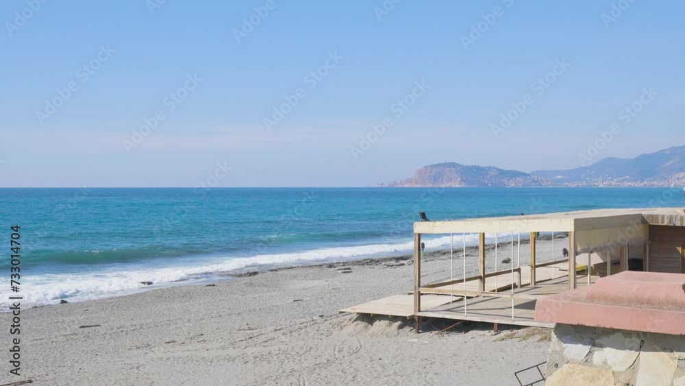 Empty Wooden Beach Bar on The Beach Shore With Clear Blue Sea Water Waves In Alanya, Turkey During Winter Empty Wooden Beach Bar on The Beach Shore With Clear Blue Sea Water Waves In Alanya, Turkey During Winter