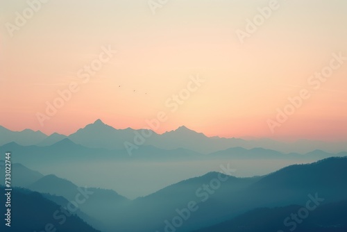 The photo captures a stunning sunset illuminating a majestic mountain range, showcasing the beauty of nature.
