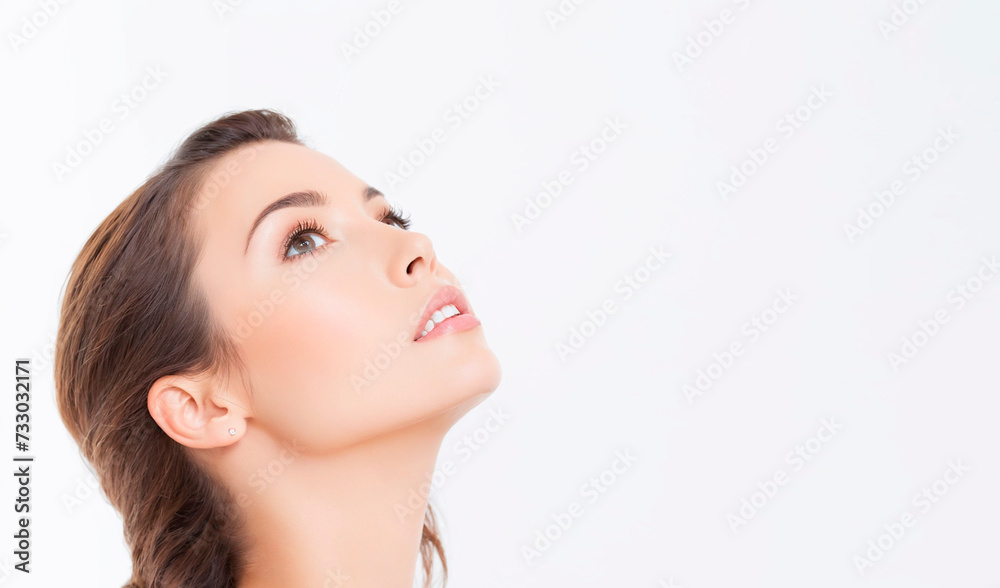 Portrait of a beautiful woman looking up, on a white background, with a space to copy. Portrait of a beautiful woman looking up, on a white background, with a space to copy.