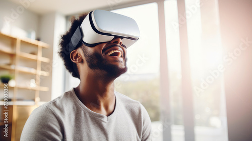 Portrait of happy smiling passionate african american black male person wearing virtual reality headset in white room.