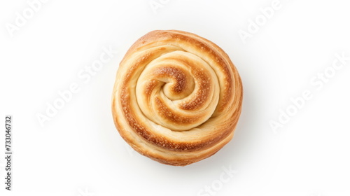 A top-view image of a flaky, golden puff pastry swirl, perfectly baked and presented on a white background