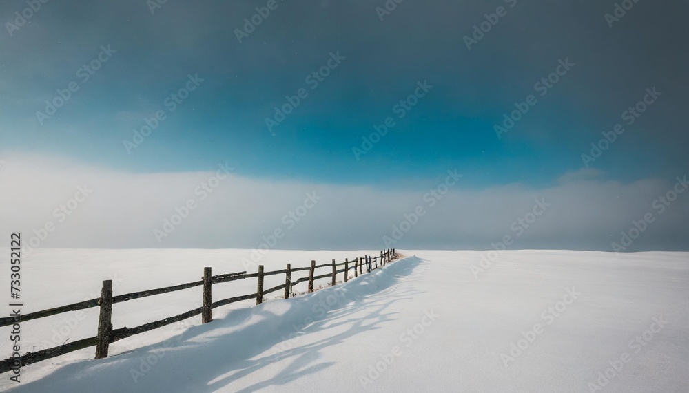 minimalistic landscape with a fence in a snowy field