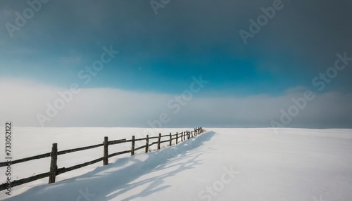minimalistic landscape with a fence in a snowy field © Debbie