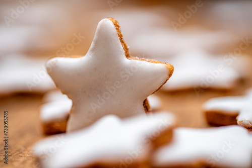 Cinnamon cookies in star shape and heart shape with white cinnamon icing photo