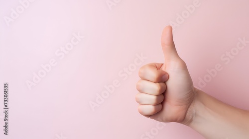 Hand of business man showing thumbs up on pink background with copy space