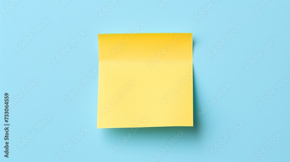 Yellow sticky note on blue background. Top view with copy space. Yellow sticky note on blue background. Top view with copy space.