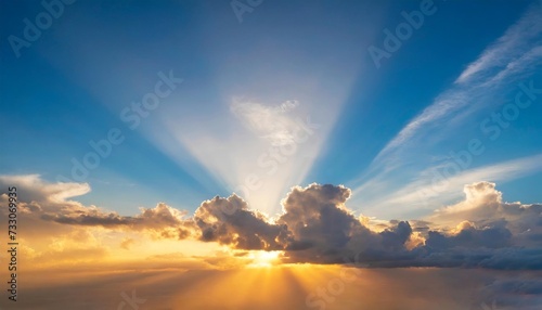 sunrise dramatic blue sky with orange sun rays breaking through the clouds nature background hope concept
