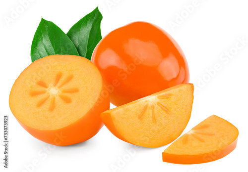 fresh ripe persimmons with cut of persimmon and green leaves isolated on white background. clipping path photo