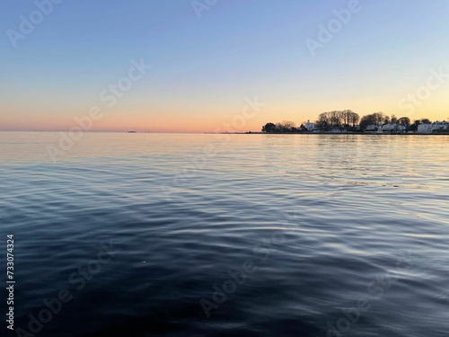 Scenic view of sunset over a tranquil lake at Bellevue Strand, Denmark © Wirestock