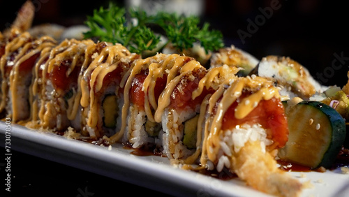 Delicious, saucy and vegetable-covered sushi rolls photo