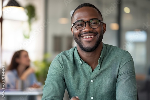  Happy African American freelancer in casual clothes sitting in a coffee shop