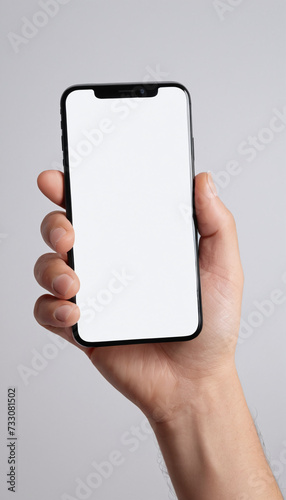 Hand holding a mobile phone with a blank screen