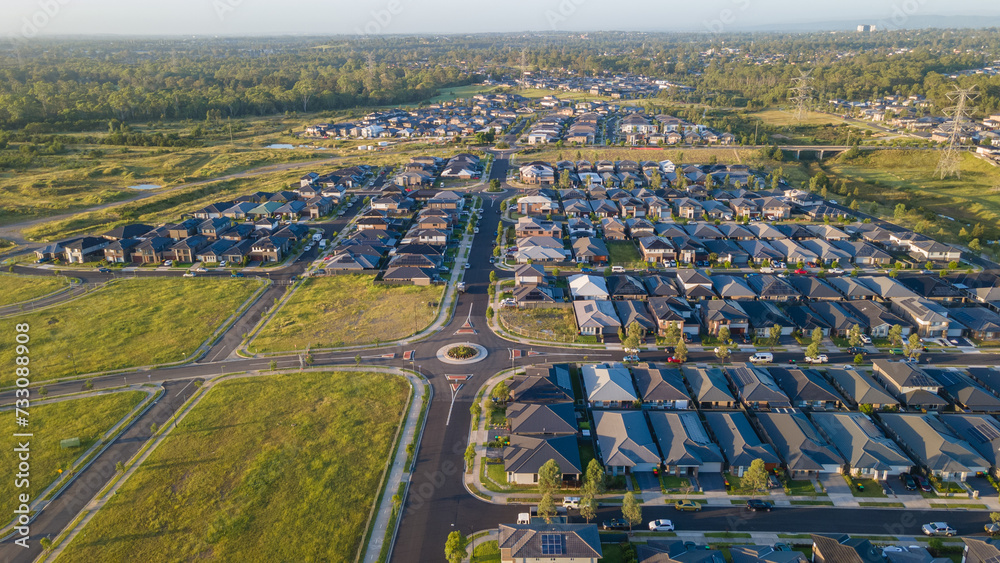 Fototapeta premium Aerial drone view of Jordan Springs East, known as the sinking suburb, in western Sydney, NSW Australia on a sunny morning in February 2024