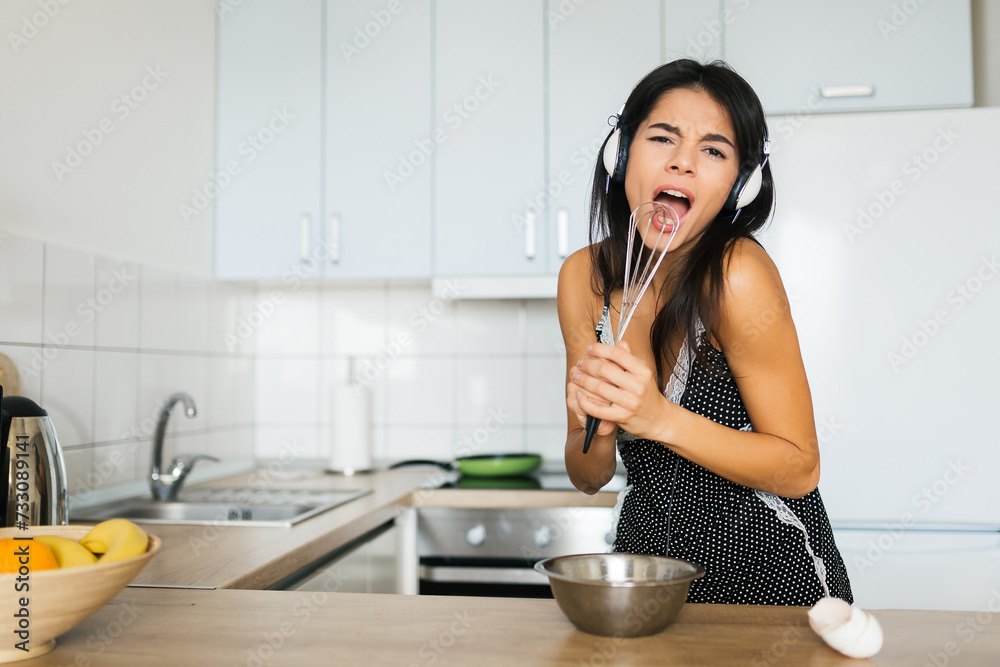 attractive smiling woman in pajamas having breakfast in kitchen attractive smiling woman in pajamas having breakfast in kitchen