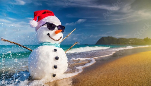 sandy snowman in christmas santa hat and sunglasses at tropical beach against waves splashes