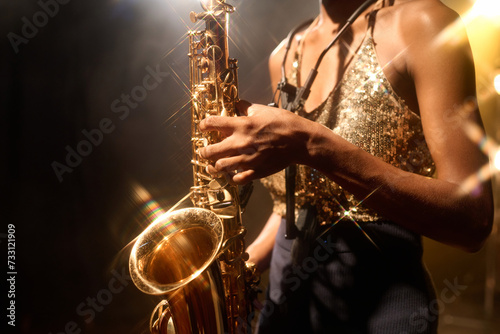 Tableau sur toile Close up of unrecognizable female musician playing jazz music focus on golden sa