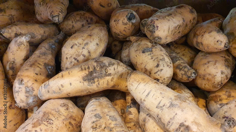 Close up pile of fresh sweet potatoes sold at the market as a background. Close up pile of fresh sweet potatoes sold at the market as a background.
