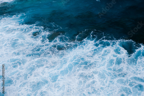 Aerial View of Ocean Waves Crashing into Rocky Coastline