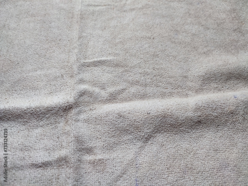 texture, pattern, background of dirty white towel exposed to sunlight