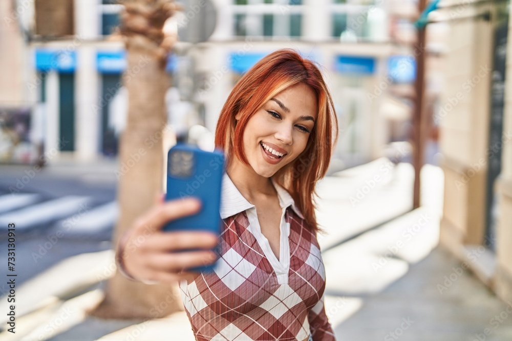 Young caucasian woman smiling confident making selfie by the smartphone at street