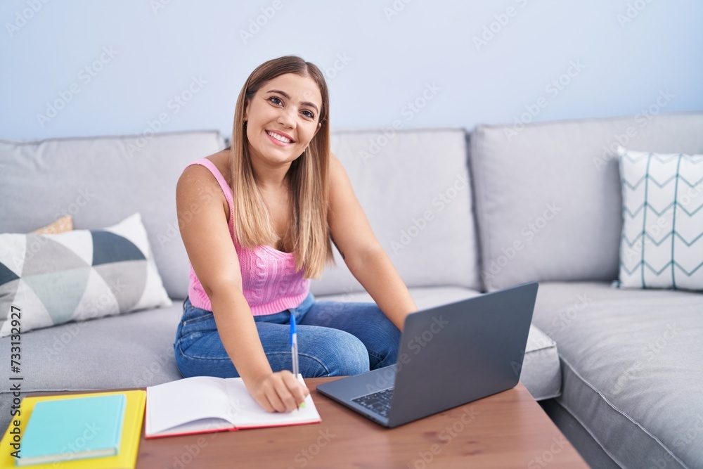 Young beautiful hispanic woman student sitting on sofa writing on notebook at home Young beautiful hispanic woman student sitting on sofa writing on notebook at home