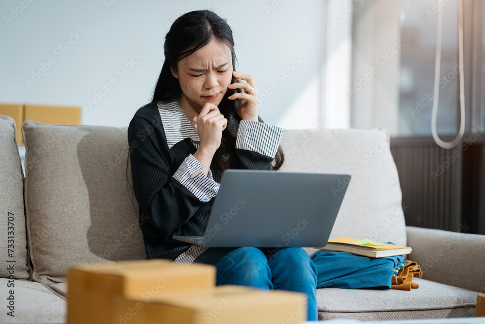 young asian women using smartphone contacted a customer asking for a shipping address young asian women using smartphone contacted a customer asking for a shipping address