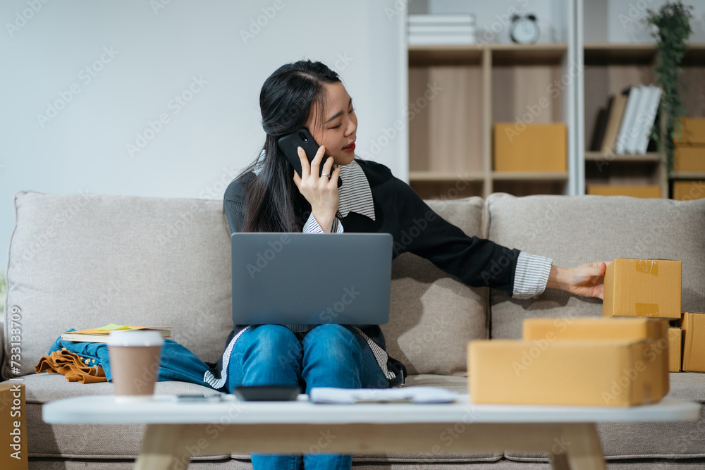 young asian women using smartphone contacted a customer asking for a shipping address young asian women using smartphone contacted a customer asking for a shipping address
