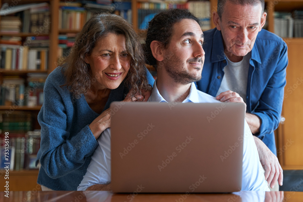 Male son teaching senior parents to use laptop Male son teaching senior parents to use laptop
