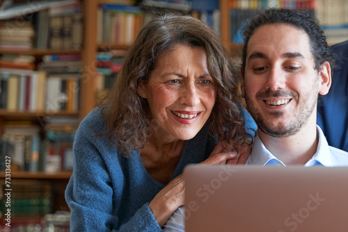 Wallpaper Mural Male son teaching senior mother how to use laptop Torontodigital.ca