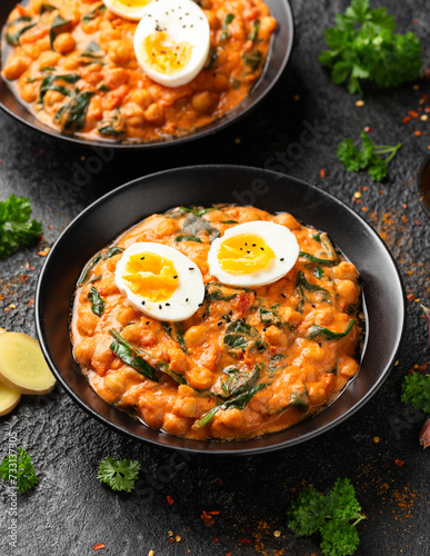 Chickpea, spinach, tomato and egg curry. Healthy food.