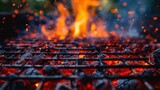 The hot charcoal grill, with flames and smoke rising, getting ready for barbecuing