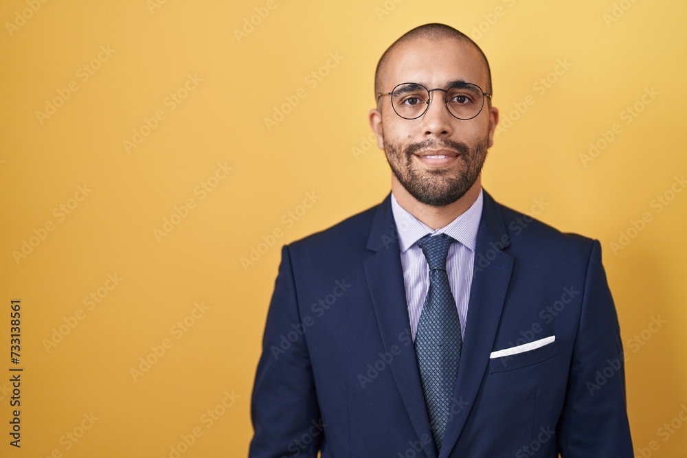 Hispanic man with beard wearing suit and tie relaxed with serious expression on face. simple and natural looking at the camera. Hispanic man with beard wearing suit and tie relaxed with serious expression on face. simple and natural looking at the camera.