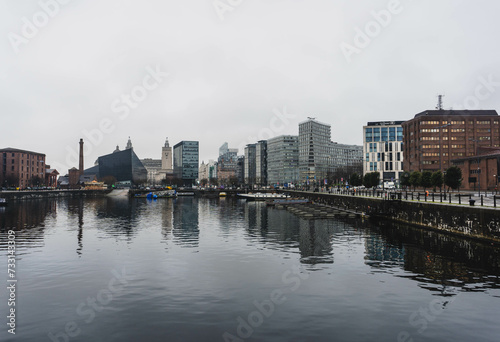 city skyline of liverpool alber docks on rainy day with modern contrast and old important buildings  © Radu