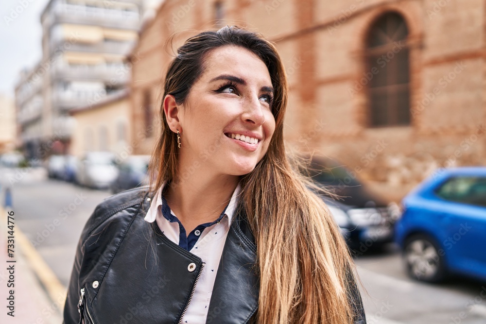 Young beautiful hispanic woman smiling confident looking to the side at street Young beautiful hispanic woman smiling confident looking to the side at street