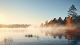 A tranquil morning mist over a quiet lake