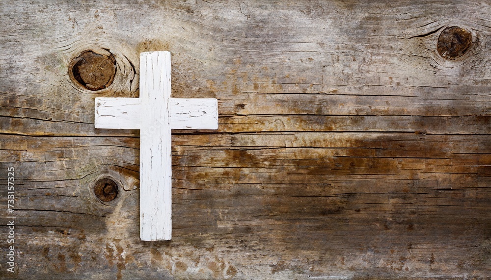 white old christian religion symbol cross shape as sign of belief on a grungy wood textured with copy space