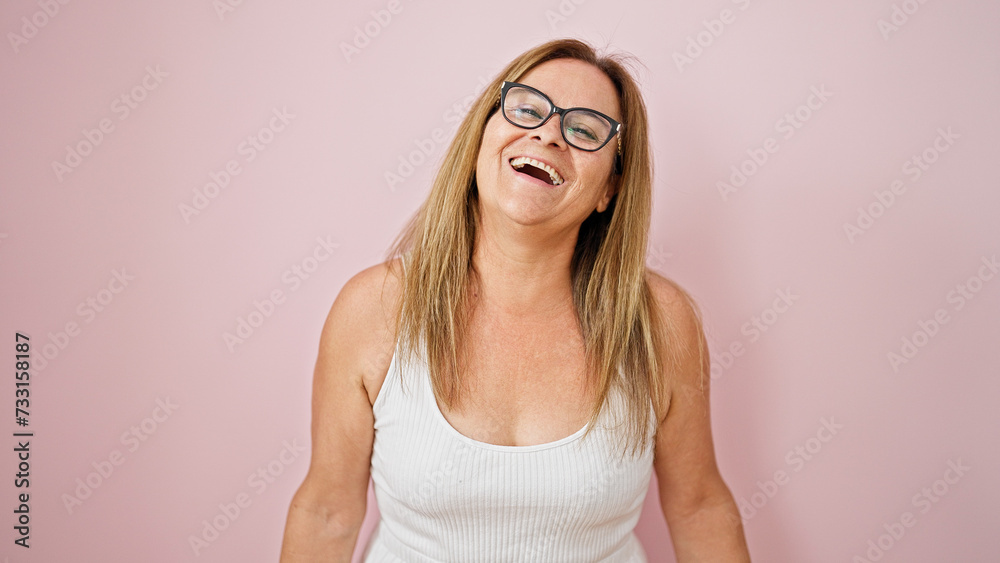 Middle age hispanic woman smiling confident standing over isolated pink background Middle age hispanic woman smiling confident standing over isolated pink background