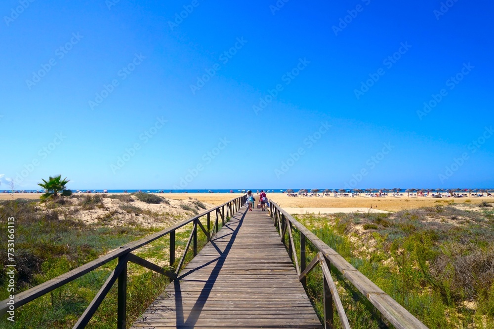Conil de la Frontera: wooden boardwalk from the city towards the beach, Playa de los Bateles, Costa de la Luz, Andalusia, Spain