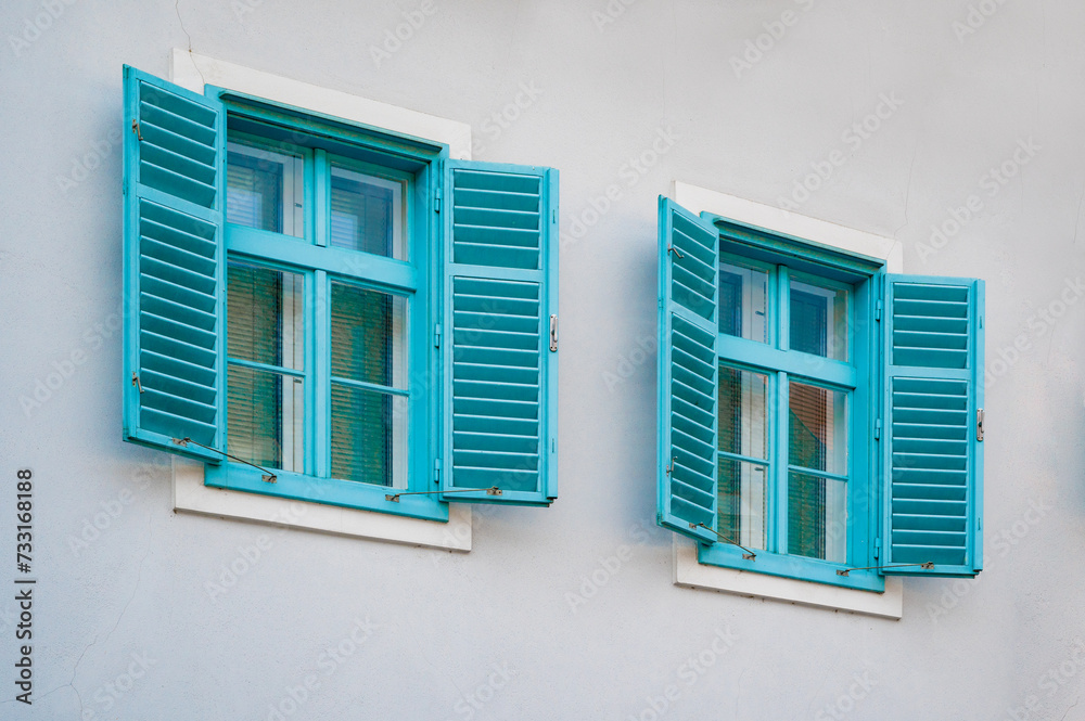 beautiful blue vintage windows with shutters in an old house