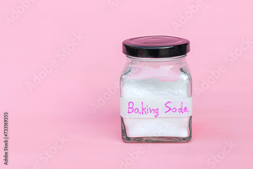 Jar of baking soda isolated on pink background
