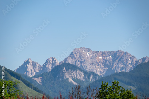 Panoramic view of untamed mountain peaks of Karawanks seen from Feistritz im Rosental, Carinthia, Austria. Looking at majestic Wertatscha summit in summer. Hiking in alpine wilderness Austrian Alps