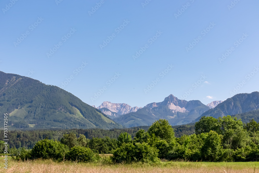 Scenic view of untamed mountain peaks of Karawanks seen from Feistritz im Rosental, Carinthia, Austria. Majestic Wertatscha and Kosiak summit in summer. Hiking in alpine wilderness Austrian Alps
