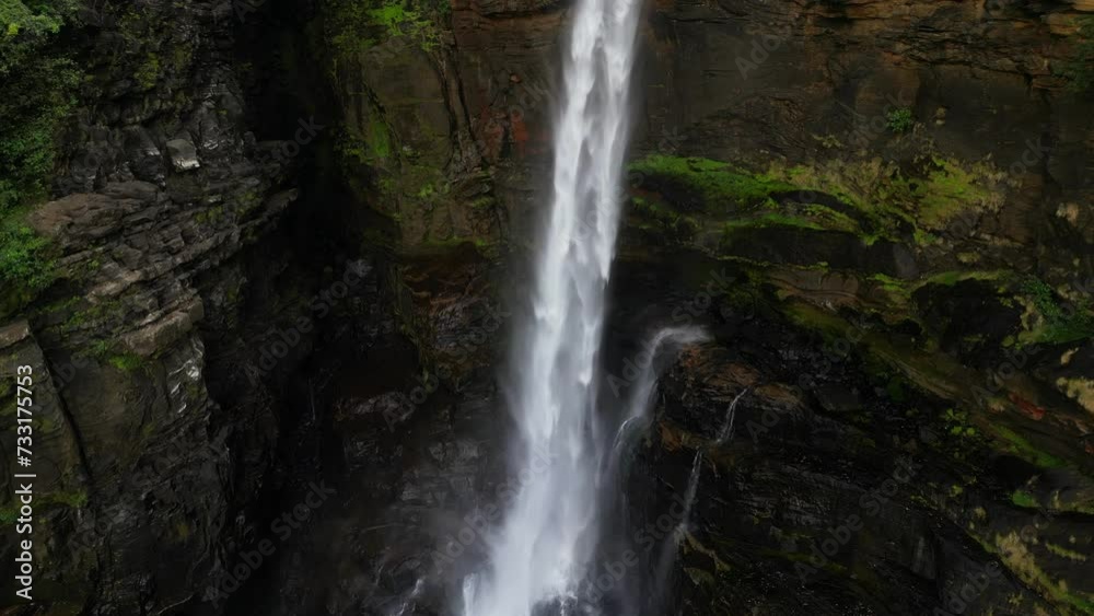 A majestic high tropical waterfall falling its stream on black rocks. Laxapana falls in Sri Lanka A majestic high tropical waterfall falling its stream on black rocks. Laxapana falls in Sri Lanka