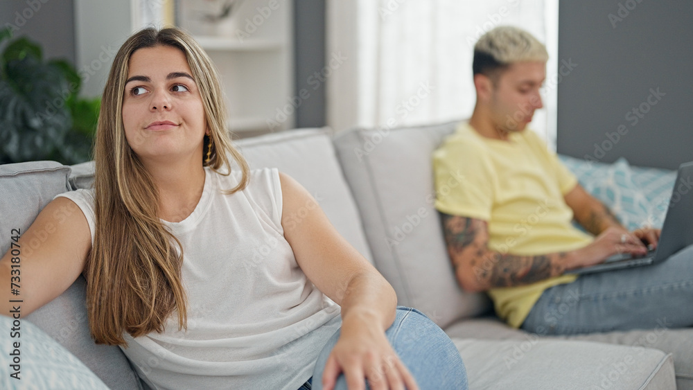 Beautiful couple sitting on sofa using laptop having problems at home Beautiful couple sitting on sofa using laptop having problems at home