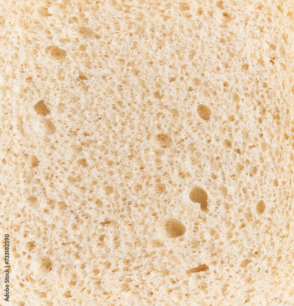 Close-up texture of a slice of white bread, showing the porous surface and air bubbles.