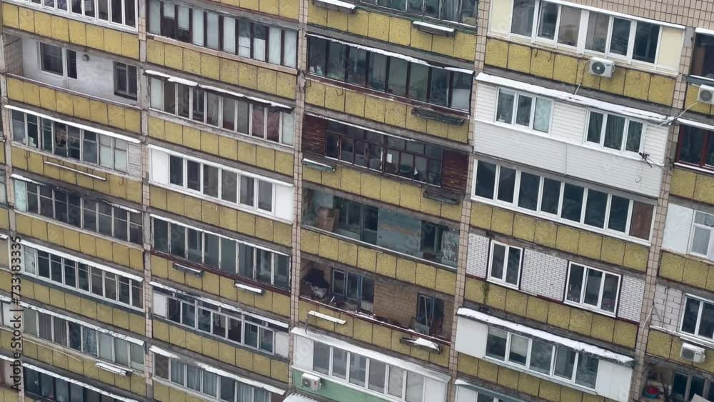 Panoramic view of a residential multi-storey building from the times of the USSR. Old and gloomy panel apartment with balconies. Soviet city residential buildings on a cloudy winter day. Panoramic view of a residential multi-storey building from the times of the USSR. Old and gloomy panel apartment with balconies. Soviet city residential buildings on a cloudy winter day.
