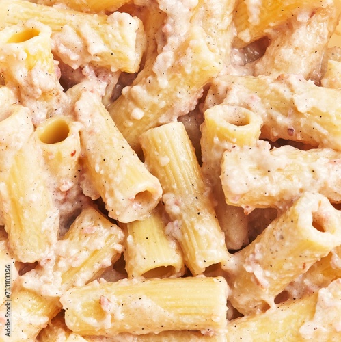 Close-up of creamy macaroni and cheese with textured sauce, a classic comfort food dish. photo