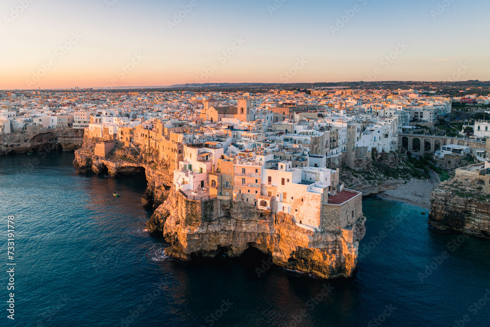 Fototapeta premium The city of Polignano a Mare during sunrise. Aerial view. Puglia, Italy.