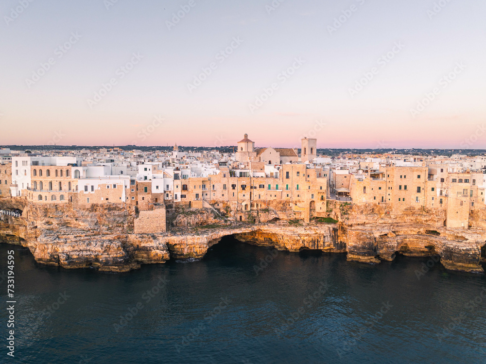 Obraz premium The city of Polignano a Mare during sunrise. Aerial view. Puglia, Italy.