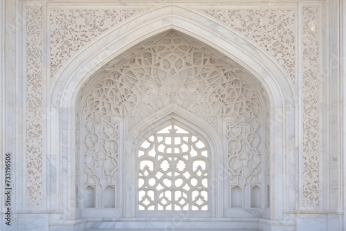 Ornamented arched vault on white marble, latticed window, view from below, close-up in India, Agra